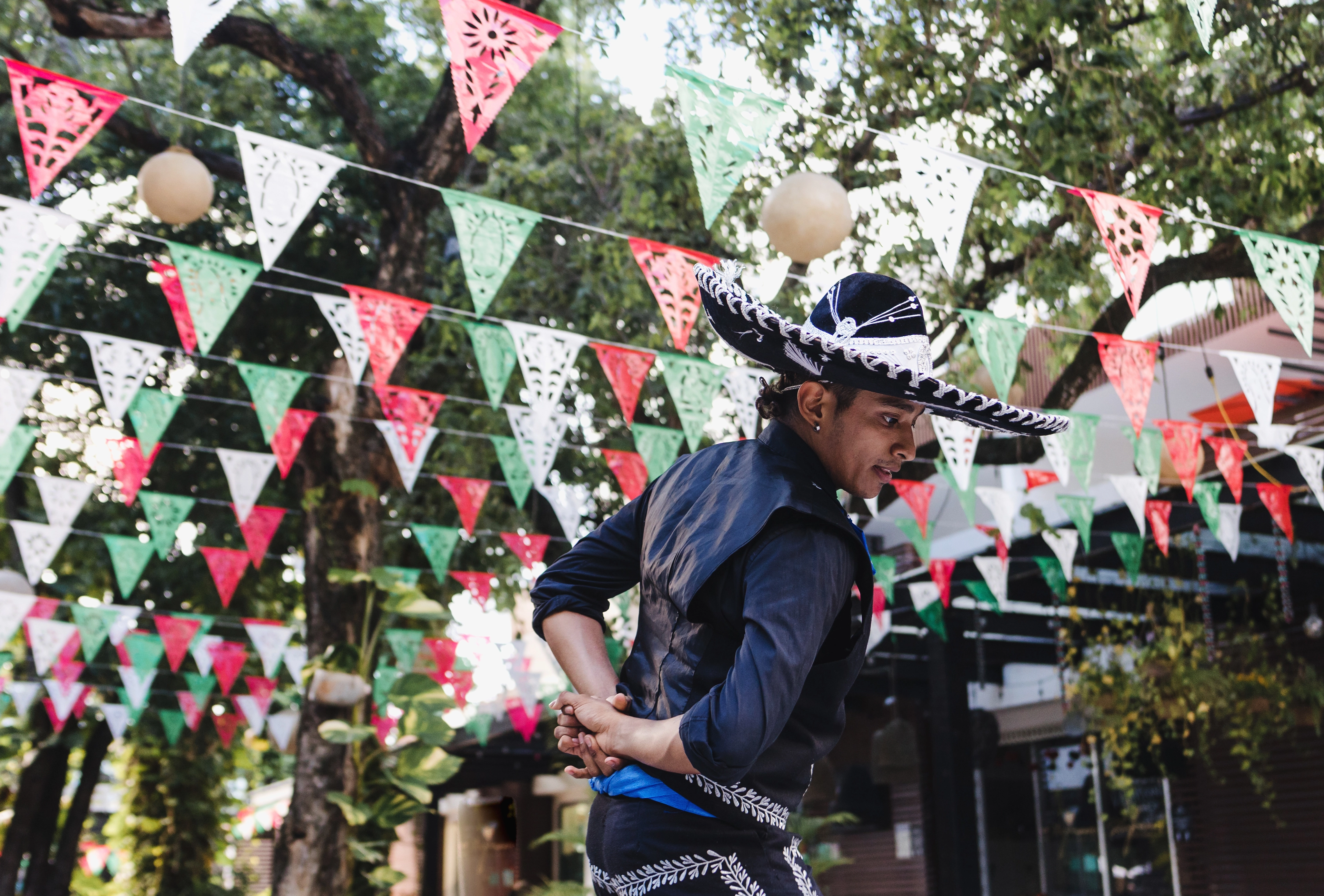 Mexican man dancing and wearing Traditional mariachi costume