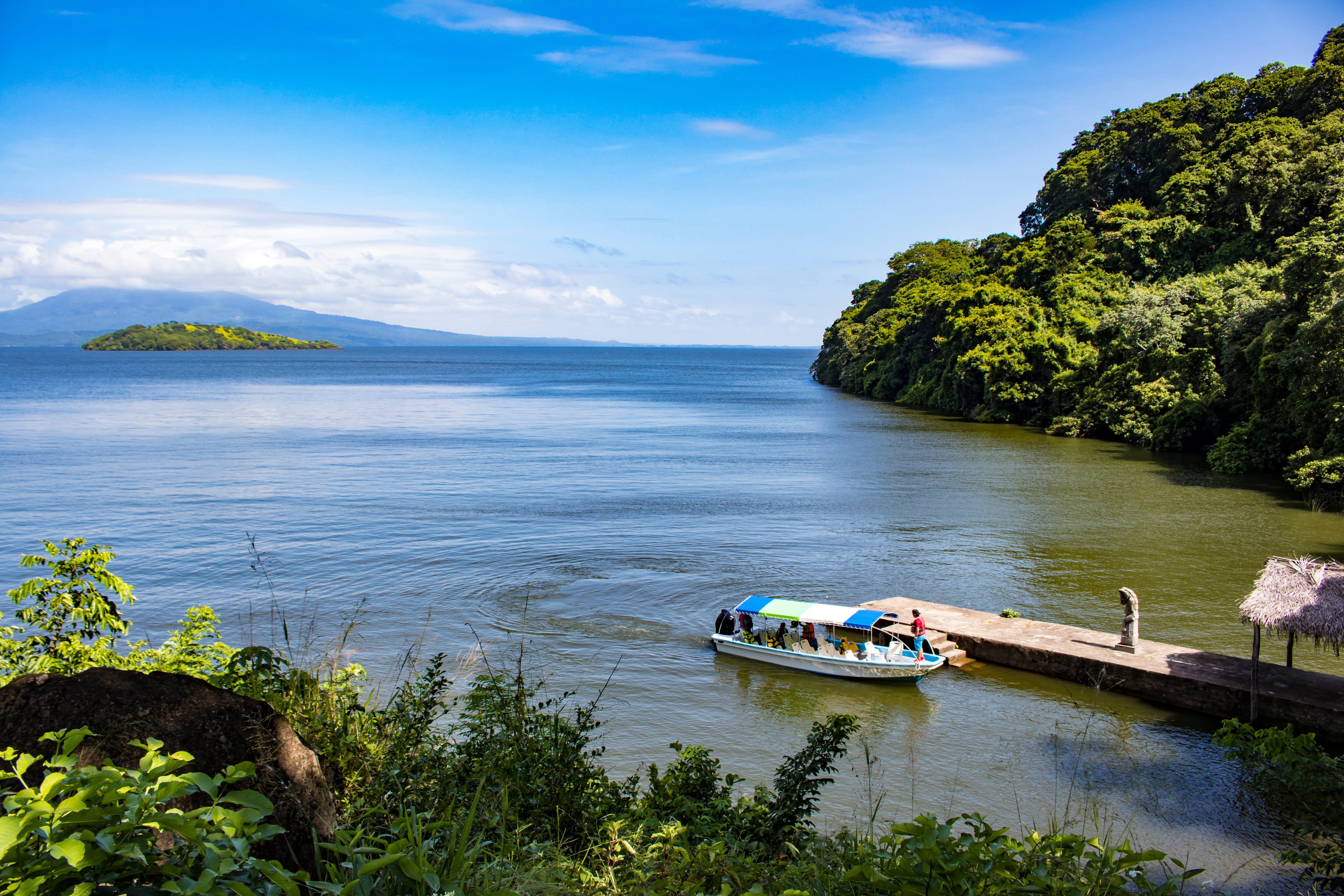 Nicaragua, Lake Nicaragua, Granada Scenic View Of A Small Boat Coming Into The Tiny Landing Port At Zapatera Island With Mombacho Volcano In The Distance On