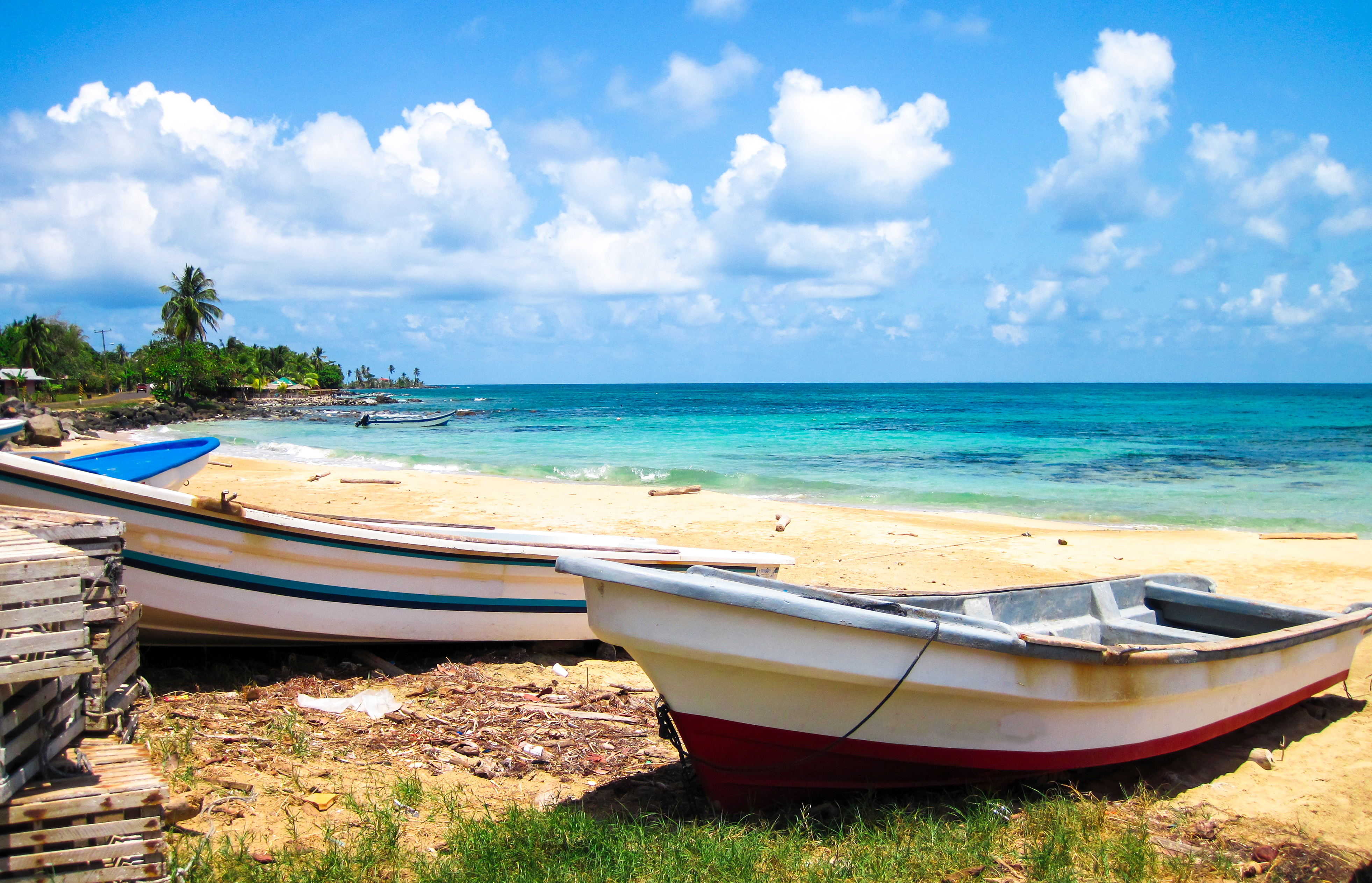 Nicaragua. Corn Islands, Fishing Boats Rest On A Tropical White Sand Beach On The Corn Islands, Nicaragua.