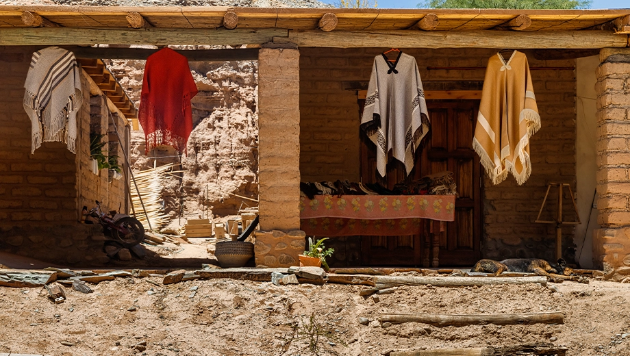 Ponchos hanging in a rustic store, Seclantás