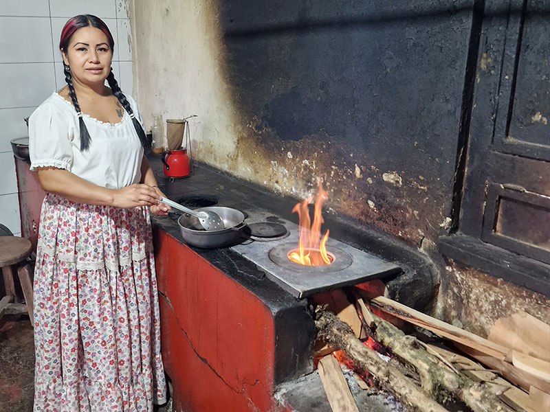 Maria roasting the coffee beans in a wood stove